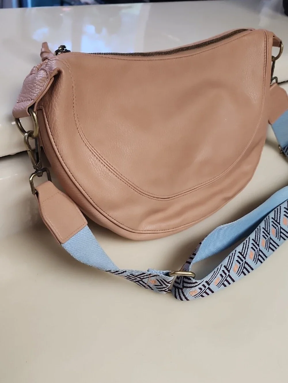 Urban Originals Peach Crescent Crossbody with Patterned Blue Strap